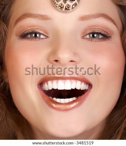 Beautiful young woman face smiling. Close up.