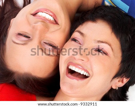 Happy young women friends laughing.