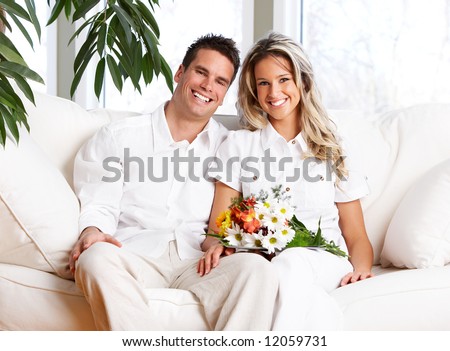 Young love couple smiling in the comfortable apartment