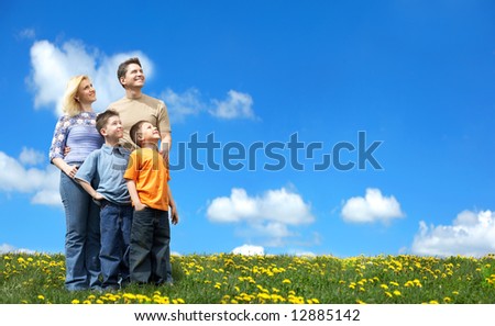 Family under blue sky. Father, mother and sons in the park