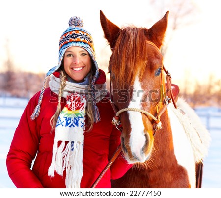 Young  happy smiling woman with horse. Winter sport