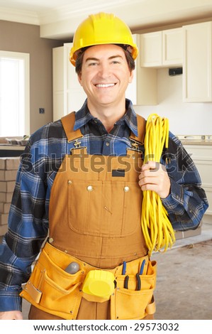 Smiling handsome builder in yellow uniform.