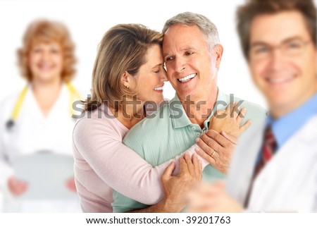 Smiling medical doctor with stethoscope and elderly couple