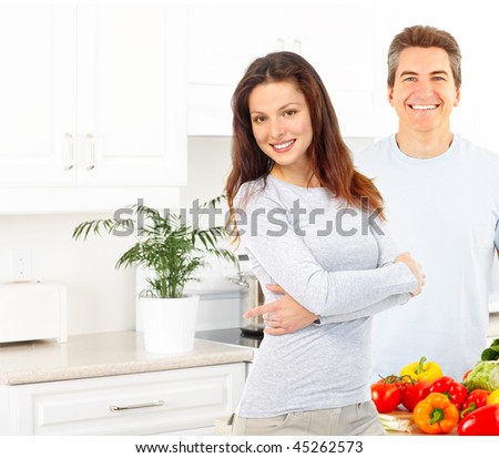 Young love couple cooking at the kitchen