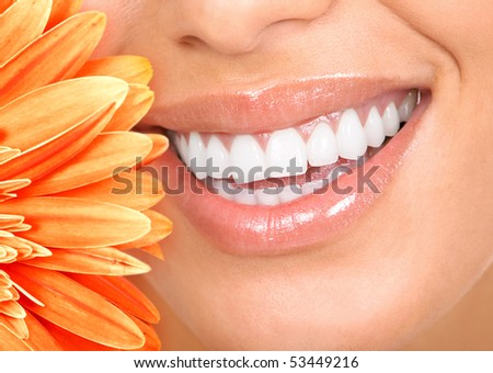 Beautiful woman smile, teeth and a fresh flower