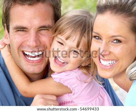 Happy family. Father, mother and daughter in the park