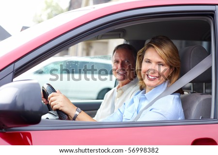 Smiling happy elderly couple in the car