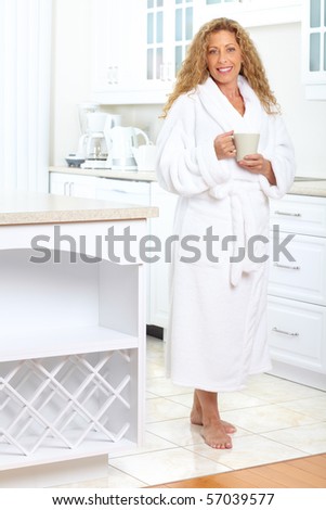 Smiling elderly woman in modern kitchen