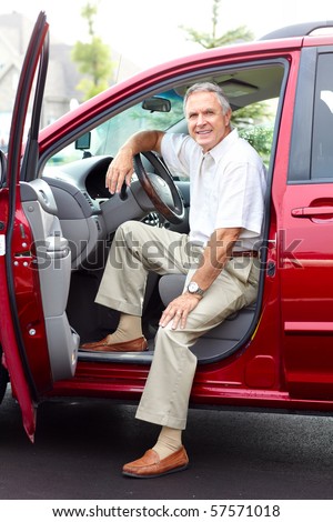 Smiling happy senior man  in the car