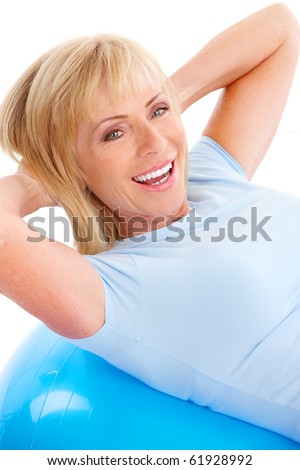 Gym & Fitness. Smiling elderly woman working out. Isolated over white background