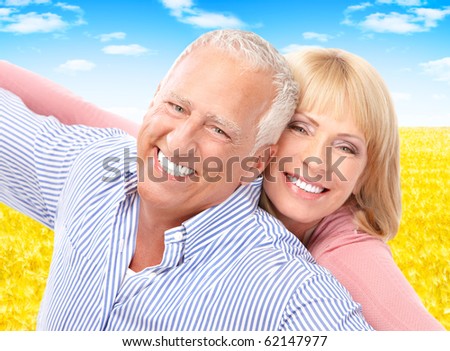 Smiling happy elderly seniors couple outdoor