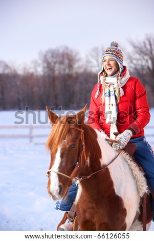 Young  happy smiling woman with horse. Winter sport