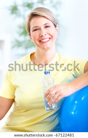 Fitness woman with a bottle of spring water