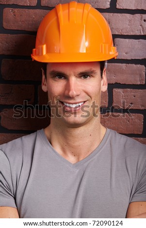 Handsome contractor. Over brick background