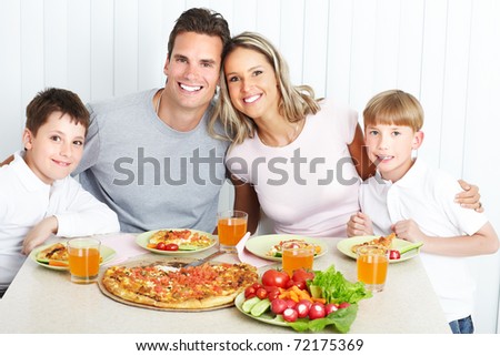Family dinner. Father, mother and children eating a big pizza