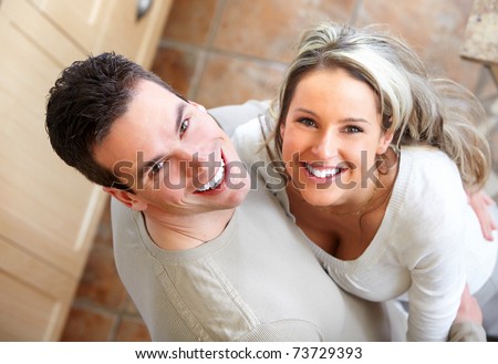 Young smiling happy couple at modern home
