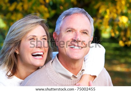 Happy elderly seniors couple in park. Love.