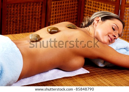 Beautiful young woman in a day spa getting therapy. Relax.