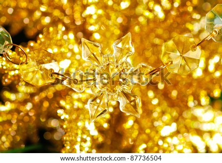 Christmas snowflake on golden sparkle background.