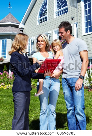 Happy family with agent realtor near new house.