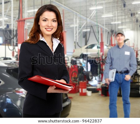 Woman manager in auto repair service. Garage.