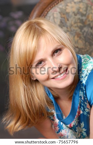 Natural portrait of attractive woman sitting on the chair