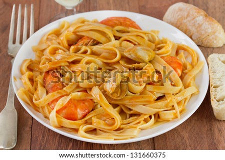 spaghetti with seafood on the white plate and bread