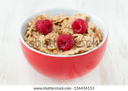 flakes with fresh berries in red bowl