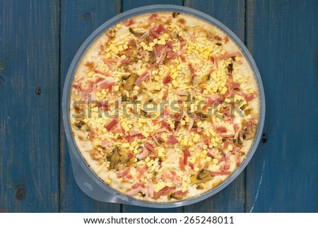 pizza in plastic in blue background