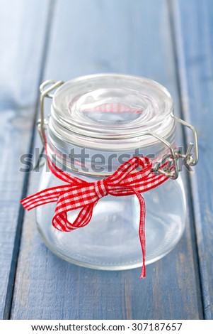 empty glass jar on blue wooden background