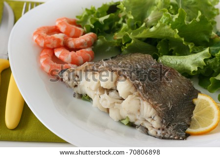 boiled fish with shrimps and salad
