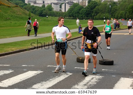 EDINBURGH, SCOTLAND, UK - MAY 23:Two men run  the Edinburgh Marathon with tires, May 23, 2010 in Edinburgh, UK