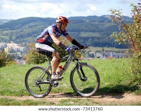 VSETIN, CZECH REPUBLIC - SEPTEMBER 9: Biker Pavel Kvasnica climbs the hill above town of Vsetin in Wallachian 50 Mountain Bike Race, September 9, 2006 in Vsetin, Czech republic.