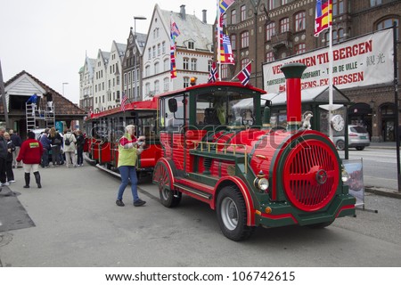 BERGEN, NORWAY - MAY 8: A road train in Bergen, Norway, on  May 8, 2012. The driver and some passengers wait to depart on a tour of the city from the UNESCO World Heritage Site, Bryggen.