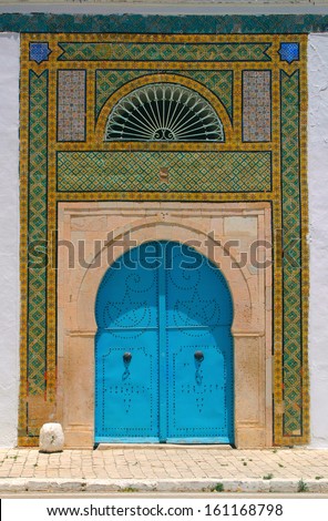 Blue door and detail of North African arab architecture - ornaments around the doors