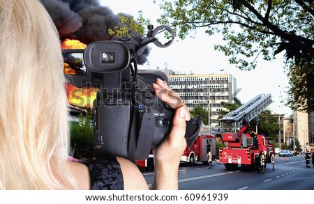 Woman videgrapher recording big fire in the city