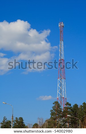 Cellular communications tower on blue sky