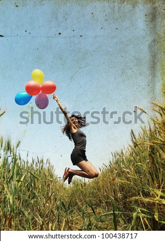 Young woman with colorful balloons. Photo in old color image style.