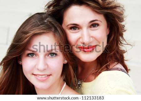 Mother and teenage daughter outside