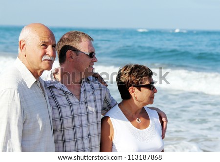 son with his parents on the beach