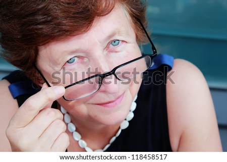 Portrait of 65-years-old beautiful woman outdoors