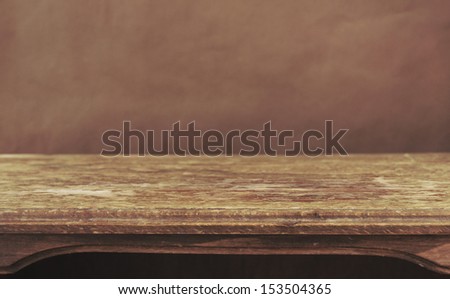 Vintage wooden table on the background of grunge wall