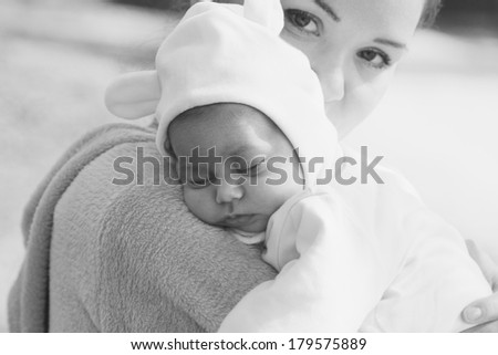 young mother with her newborn baby outdoor