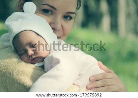 young mother with her newborn baby outdoor