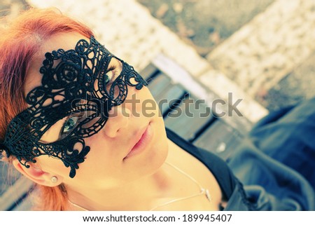 portrait of beautiful woman in mask outdoors