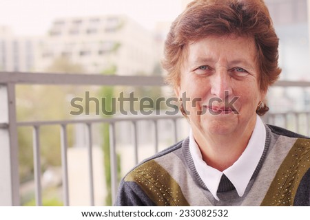 Happy senior caucasian woman travelling in the streets of Jerusalem - active retirement concept