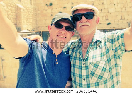Selfie portrait of father and adult son near the Western Wall in Jerusalem