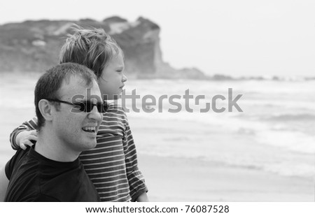 Dad and son at sea, black and white photo