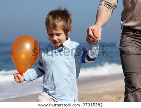 father holds the hand of his son