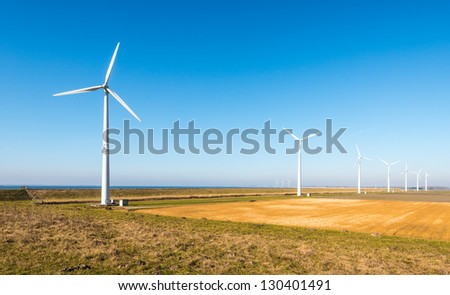 Colorful landscape with a row of modern wind turbines in the Netherlands.